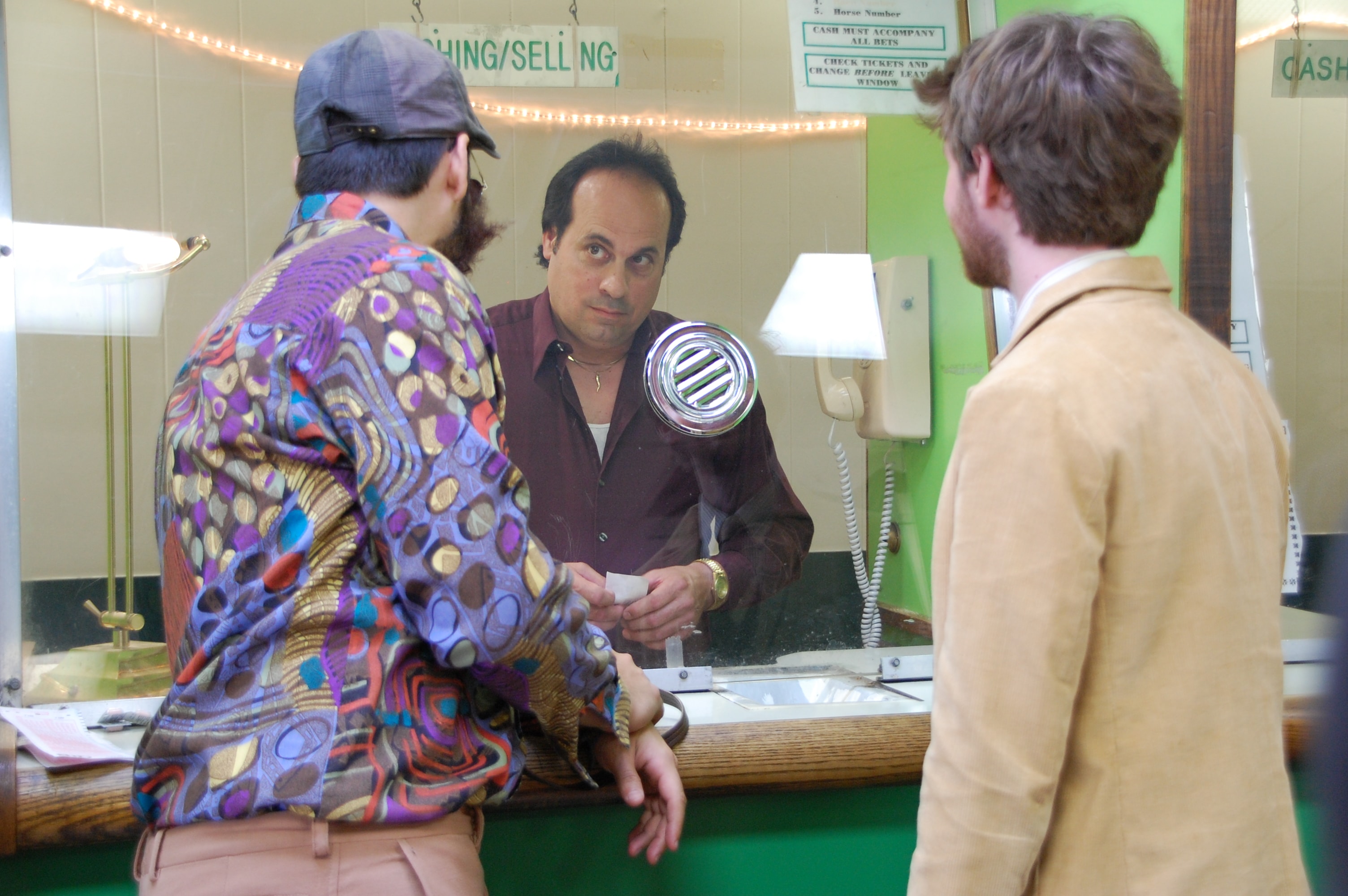 Three men at a betting window